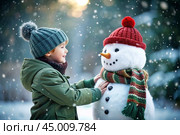 A happy child playing with snow. A charming little boy is making a snowman in a heavy snowfall. Winter activities for children. Стоковое AI-изображение, AI-художник Photojuli / Фотобанк Лори