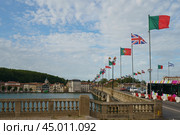 Bayonne, France - June 19, 2019: Saint-Esprit bridge with flags over the Adour River. Flags of countries of European Union. Редакционное фото, фотограф YuryKara / Фотобанк Лори