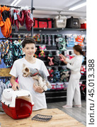 Teen boy choose carrier for small pet Yorkshire terrier dog. Стоковое фото, фотограф Яков Филимонов / Фотобанк Лори