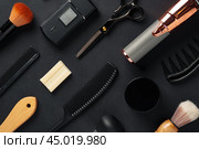 An Assortment of Professional Hairdressing Tools Laid Out on a Dark Surface. Стоковое фото, фотограф Сергей Толмачёв / Фотобанк Лори