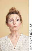 Woman with surprised exaggerated expression on neutral background. Стоковое AI-изображение, AI-художник Анастасия Золотницкая / Фотобанк Лори