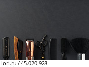 An Assortment of Professional Hairdressing Tools Laid Out on a Dark Surface. Стоковое фото, фотограф Сергей Толмачёв / Фотобанк Лори