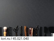 An Assortment of Professional Hairdressing Tools Laid Out on a Dark Surface. Стоковое фото, фотограф Сергей Толмачёв / Фотобанк Лори