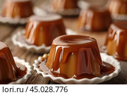 Delicious creme caramel puddings covered in caramel sauce. Стоковое AI-изображение, AI-художник Иван Рябоконь / Фотобанк Лори