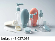 Variety of travel-sized containers displayed against a bright blue background. Стоковое фото, фотограф Сергей Толмачёв / Фотобанк Лори
