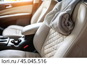 Close up of towel hanging on headrest inside car. Стоковое AI-изображение, AI-художник Иван Рябоконь / Фотобанк Лори