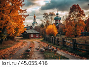Autumn landscape. A small cozy church in the village. The trees are painted in bright autumn colors. An atmosphere of peace and harmony with nature. Стоковое AI-изображение, AI-художник Photojuli / Фотобанк Лори
