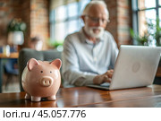 Pension. Saving money. Savings. Piggy bank in the form of a pig in close-up, Calculating the total amount of the budget. An elderly man learns how to interact with a laptop in online payments, finance, loans, transactions. Стоковое AI-изображение, AI-художник Photojuli / Фотобанк Лори