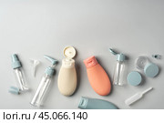 Variety of travel-sized containers displayed against a bright blue background. Стоковое фото, фотограф Сергей Толмачёв / Фотобанк Лори