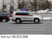 Машина МЧС мчится по улице города. Автомобиль с включенным проблесковым маячком и сиреной спешит на вызов. Редакционное фото, фотограф Константин Григорьев / Фотобанк Лори