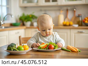 Healthy baby food. The first meal. Feeding the baby. A cute kid tastes fresh vegetables. Стоковое AI-изображение, AI-художник Photojuli / Фотобанк Лори