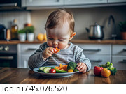 Healthy baby food. The first meal. Feeding the baby. A cute kid tastes fresh vegetables. Стоковое AI-изображение, AI-художник Photojuli / Фотобанк Лори