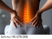 Lumbar intervertebral spine hernia, woman with back pain on a gray background, spinal disc disease. Стоковое AI-изображение, AI-художник Станислав Тарко / Фотобанк Лори