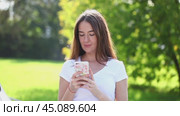SMS by phone. Beautiful woman is reading a message on her cell phone. Стоковое видео, видеограф Андрей Аркуша / Фотобанк Лори