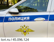 Надпись "Полиция" на служебном автомобиле ГАИ (2024) / A police car is standing on the road. The inscription "Police" close-up.. Редакционное фото, фотограф Iva Noel / Фотобанк Лори