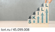 Upskilling and personal development concept. Skill training, education, learning, ability, knowledge and competency. Upskilling, reskilling, new skills icon on wooden cube. copy space. Стоковое фото, фотограф Павел Муравьев / Фотобанк Лори