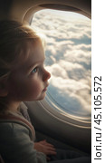 Wonderstruck child gazing at cloudscape through airplane window. Стоковое AI-изображение, AI-художник Sabyna75 / Фотобанк Лори