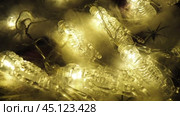 Transparent skeletons glowing yellow, close-up. Transform your space with a whimsical garland featuring glowing skeleton skulls and bones, perfect for Halloween festivities and ambiance. Horror theme. Стоковое видео, видеограф Юлия Петровская / Фотобанк Лори