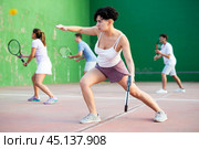 Sportive woman in shorts and t-shirt playing frontenis on court. Стоковое фото, фотограф Яков Филимонов / Фотобанк Лори