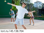 Sports active man during friendly doubles couple match. Two men playing frontenis together outdoor. Стоковое фото, фотограф Яков Филимонов / Фотобанк Лори