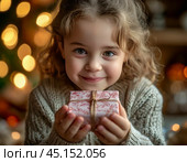 A little girl is happy with a gift, which she opens with great curiosity. The festive atmosphere of New Year and Christmas. Стоковое AI-изображение, AI-художник Сергей Елизарьев / Фотобанк Лори