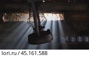 A wooden dugout in which a kerosene lamp burns. Light from the window penetrates into the room. Стоковое видео, видеограф Александр Кузовков / Фотобанк Лори