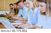 Side view of a group of adult students in university classroom. Стоковое видео, видеограф Яков Филимонов / Фотобанк Лори