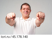 An older man smiling and reaching out with both hands. Стоковое фото, фотограф Сергей Толмачёв / Фотобанк Лори