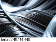 Arrangement of smooth gray lines gracefully intertwines against a soft abstract bokeh background, adding depth and allure. Composition invites the viewer to explore its fluid design. Generative AI. Стоковое AI-изображение, AI-художник Юлия Петровская / Фотобанк Лори