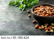 Вкусные орешки в красивой деревянной миске. Copy ad text space. Стоковое AI-изображение, AI-художник Щеголева Ольга / Фотобанк Лори