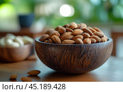 Вкусные миндальные орешки в красивой деревянной миске. Copy ad text space. Стоковое AI-изображение, AI-художник Щеголева Ольга / Фотобанк Лори