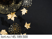 The inscription happy Halloween. Modern background with black bats, Golden leaves, cobwebs and wooden letters. Halloween with copy space for text. Flat lay, top. Стоковое фото, фотограф Photojuli / Фотобанк Лори