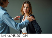 Office harassment depiction, male supervisor touching young female worker shoulder, causing discomfort. Professional woman in business suit shows unease, inappropriate contact, power imbalance. Стоковое AI-изображение, AI-художник Павел Муравьев / Фотобанк Лори