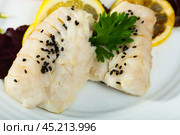 Closeup of codfish steamed and served with herbs and lemon. Стоковое фото, фотограф Яков Филимонов / Фотобанк Лори