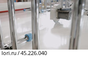 Metal sheets, coated with a white adhesive layer, are sliced using a circular saw during the manufacturing process of panels. Стоковое видео, видеограф Strunov David / Фотобанк Лори