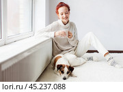 Young Woman Drinking hot coffee at white room. Стоковое фото, фотограф Гладских Татьяна / Фотобанк Лори