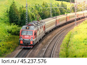 Modern Passenger Train on Scenic Railway Track in Rural Landscape surrounded by nature and trees Electric train, Russian Railways Krasnoyarsk, Russia, July 27, 2024. Редакционное фото, фотограф Владимир Разгуляев / Фотобанк Лори