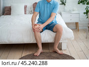 Knee pain, joint inflammation, arthritis and degenerative changes, man suffering from leg ache and doing self-massage. Стоковое фото, фотограф Станислав Тарко / Фотобанк Лори