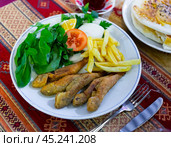 Fried red mullet with vegetable garnish in Turkish restaurant. Стоковое фото, фотограф Яков Филимонов / Фотобанк Лори