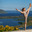 Fitness portrait young athletic woman doing gymnastics on blue sky background. Стоковое фото, фотограф Андрей Аркуша / Фотобанк Лори