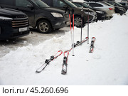 Kirovsk, Murmansk region, Russia, March 19, 2024: Alpine skis and poles at car park on Southern slope of Bolshoy Vudyavr ski resort in Khibiny Mountains. Редакционное фото, фотограф Алексей Антипов / Фотобанк Лори