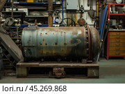 Old rusty industrial autoclave in disused factory. Стоковое AI-изображение, AI-художник Иван Рябоконь / Фотобанк Лори