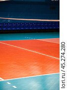 Professional volleyball court with net and row chairs in sporty gym. Sport backgrounds, volleyball courts in sport hall. Team game success, healthy sporty lifestyle concept. Copy ad text space banner. Стоковое фото, фотограф Aleksandr Golubev / Фотобанк Лори