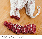Spanish sausage fuet on a wooden table, closeup. Стоковое фото, фотограф Яков Филимонов / Фотобанк Лори