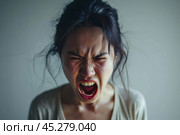 Screaming, hate, rage. Crying emotional angry asian woman screaming and yelling on gray studio background. Emotional, young face. Female close up portrait. Human emotions, facial expression concept. Стоковое AI-изображение, AI-художник Sergey Grishin / Фотобанк Лори