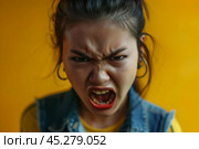 Portrait of angry emotional Asian girl screaming and frustrated shouting with anger, crazy and yelling on white background, Concept of attention deficit hyperactivity disorder (ADHD) Стоковое AI-изображение, AI-художник Sergey Grishin / Фотобанк Лори