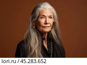 Unamused sad miserable mature long grey haired caucasian woman wearing black blouse, frowns face with dissatisfaction, sulks troubled as someone hurt her feelings. Indoor studio shot isolated on brown. Стоковое AI-изображение, AI-художник Sergey Grishin / Фотобанк Лори