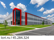 Modern warehouse facade on a sunny day, distribution center. Industrial Building of modern logistics hub. Loading dock. Large Business Entrance. Innovative logistic complex exterior. Cargo storage. Стоковое AI-изображение, AI-художник Марина Демидюк / Фотобанк Лори
