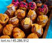 Assorted sweet cruffins topped with variety of creams. Стоковое фото, фотограф Яков Филимонов / Фотобанк Лори