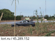 The aftermath of hurricane Dana in Valencia, Spain - Abandoned car submerged in floodwaters after devastating Valencia storm. Редакционное фото, фотограф Данил Руденко / Фотобанк Лори
